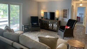 A living room with a ceiling fan, a television, two chairs, a sofa, and a small table. - WATERFRONT Vacation! {3 bed 2 bath.  Sleeps 13} (Goreville)