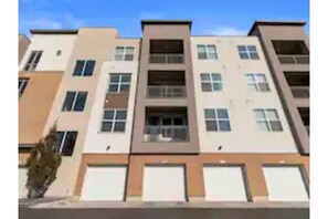 Stylish residential building with balconies on each floor, offering outdoor space for residents.