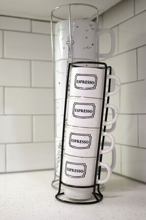 A white mug rack with four white mugs, each labeled 'ESPRESSO,' against a white tiled wall. - Luxury Modern Apartment In Atlanta wFree Parking  (Atlanta)