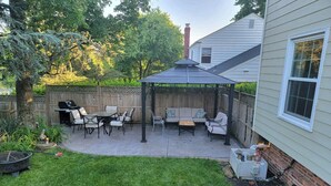 A backyard patio with a covered seating area, a grill, and a fire pit. - Great Delray, Alexandria, One bed, bath, kitchen NOT share, big backyard, metro, (Alexandria)