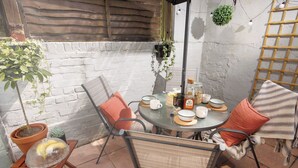 A round table with chairs, a potted plant, and a hanging plant. - Luxury for 2024, Central Plymouth Home for 10 (Plymouth)