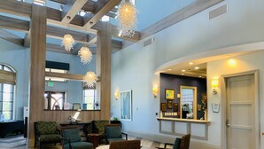 A spacious lobby with high ceilings, modern chandeliers, and comfortable seating areas. - 7BR Champions Gate Resort/Private Pool & Spa/15 min to Disney/Sleeps 16+ (Davenport)