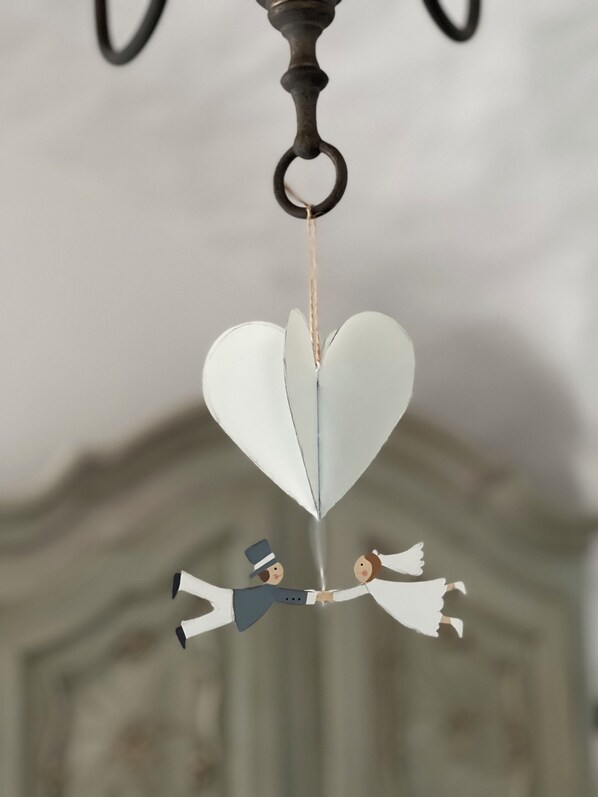A chandelier with a heart-shaped decoration hanging from it.