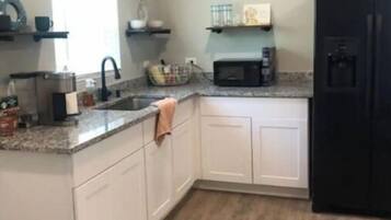 Fridge, microwave, coffee/tea maker, cookware/dishes/utensils