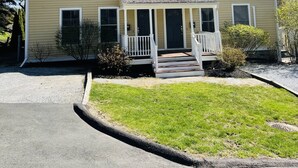 A two-story house with a front porch, multiple windows, and a chimney. - Perfect location in the heart of downtown Lenox (Lenox)