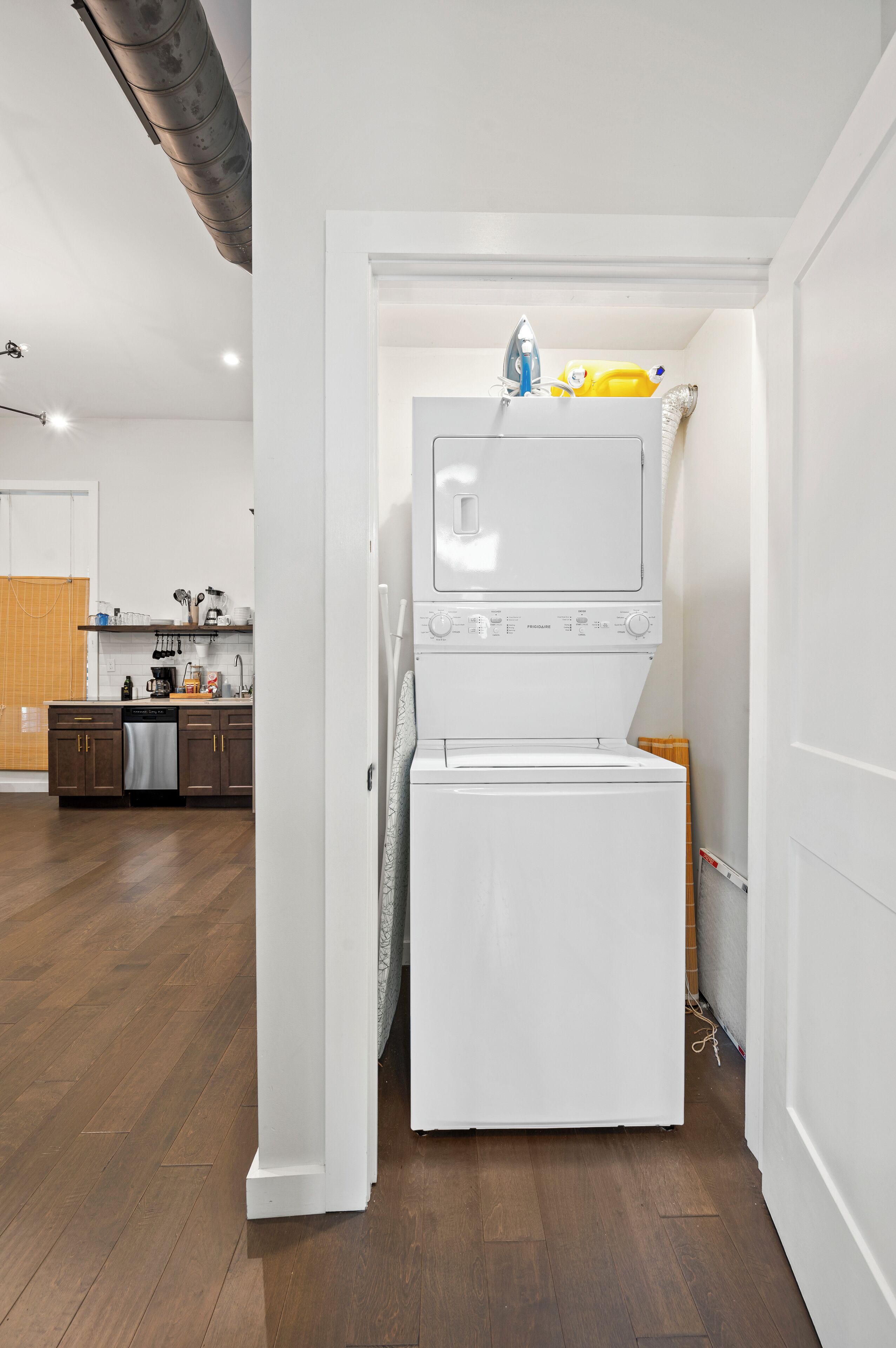 A compact kitchen with a dishwasher, a microwave, and a built-in oven.