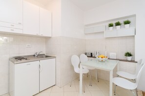 Fridge, stovetop, toaster, cookware/dishes/utensils