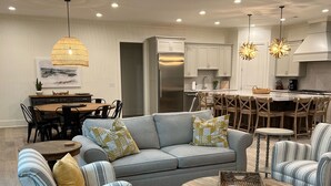 A modern living room with a gray sofa, striped armchairs, and a coffee table. - Carolina’s Cottage Cove-Lake Keowee (Seneca)