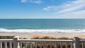 A beach view with a wooden railing in the foreground. - Oceanfront views, Beachfront condo, The Driftwood! (north topsail beach)
