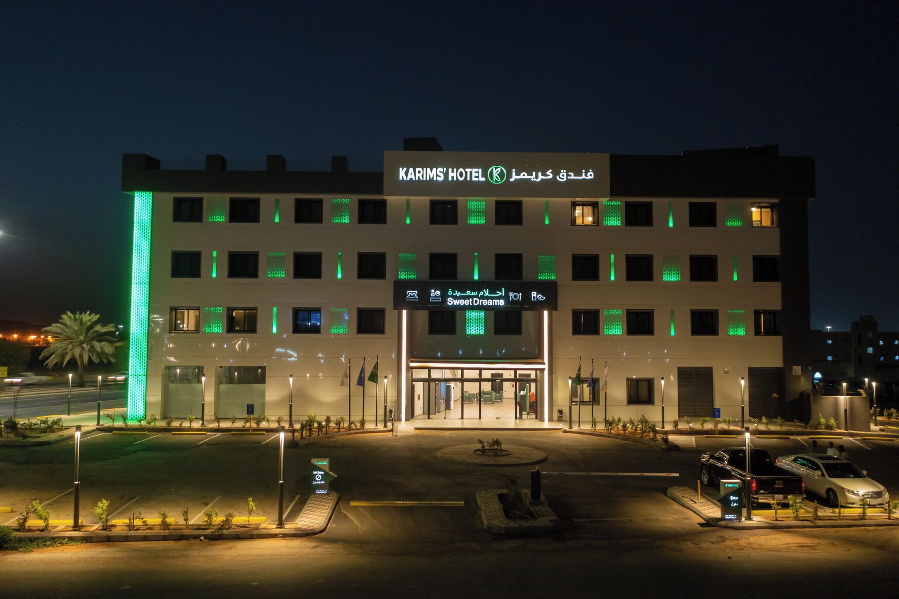 A hotel with multiple floors, a prominent entrance, and a sign indicating a 'Sweet Dreams' restaurant.