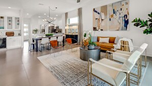 A modern living room with a sofa, chairs, a coffee table, and artwork on the wall. - ☀ Bike to Ritz & Beaches, 3 Kings, 2 Masters, Easy, Bikes, Heated Pool ☀ (Naples)