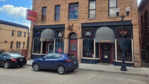 A historic building with a restaurant, a saloon, and a Bud Light sign. - The Stampmill Victorian Suites (Lead)
