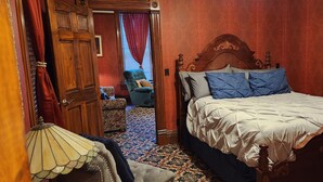 A bedroom with a four-poster bed, a patterned carpet, and a wooden wardrobe. - The Stampmill Victorian Suites (Lead)