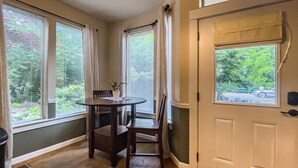 A room with a wooden floor, a round table with chairs, and a door with a window. - Jacksonville Towne Square.  (Jacksonville)