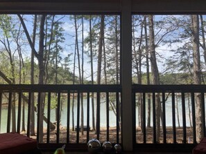 A room with a large window overlooking a forested area and a body of water. - Uncork, Unwind, Relax @ this Family & pet Friendly Lake Home #1 (Martin)