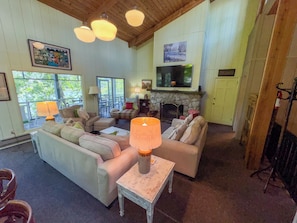 A cozy living room with a fireplace, comfortable seating, and a television.