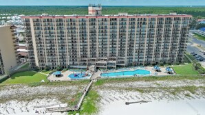A high-rise hotel with multiple balconies, a swimming pool, and a beach area. - LUXURY PHOENIX UNIT, GREAT FOR FAMILIES, TONS OF AMENTIES (Orange Beach)