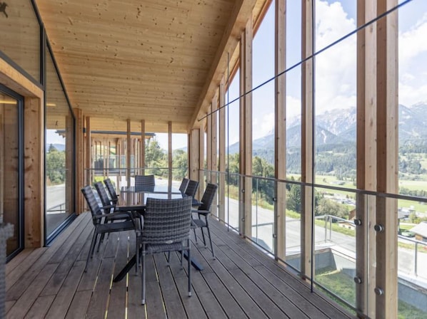 Enjoy dining or socializing on the balcony with scenic views of mountains and greenery.