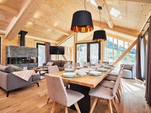 Enjoy meals in the dining area with a stone fireplace and flat-screen TV.