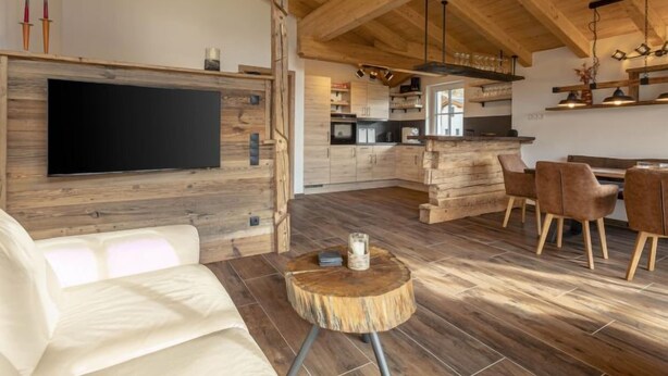 A modern kitchen with wooden cabinets and a built-in oven. - Premium # 1A mit Sauna by Interhome (Uttendorf)