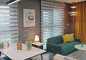 Junior Suite | Living area | 65-inch TV with digital channels