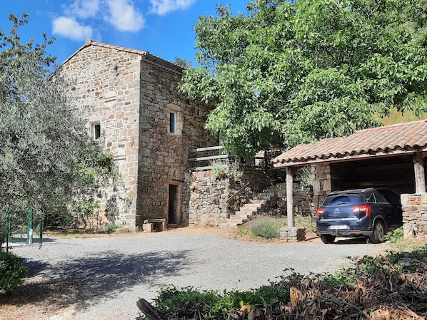 A stone building with a car parked in front.
