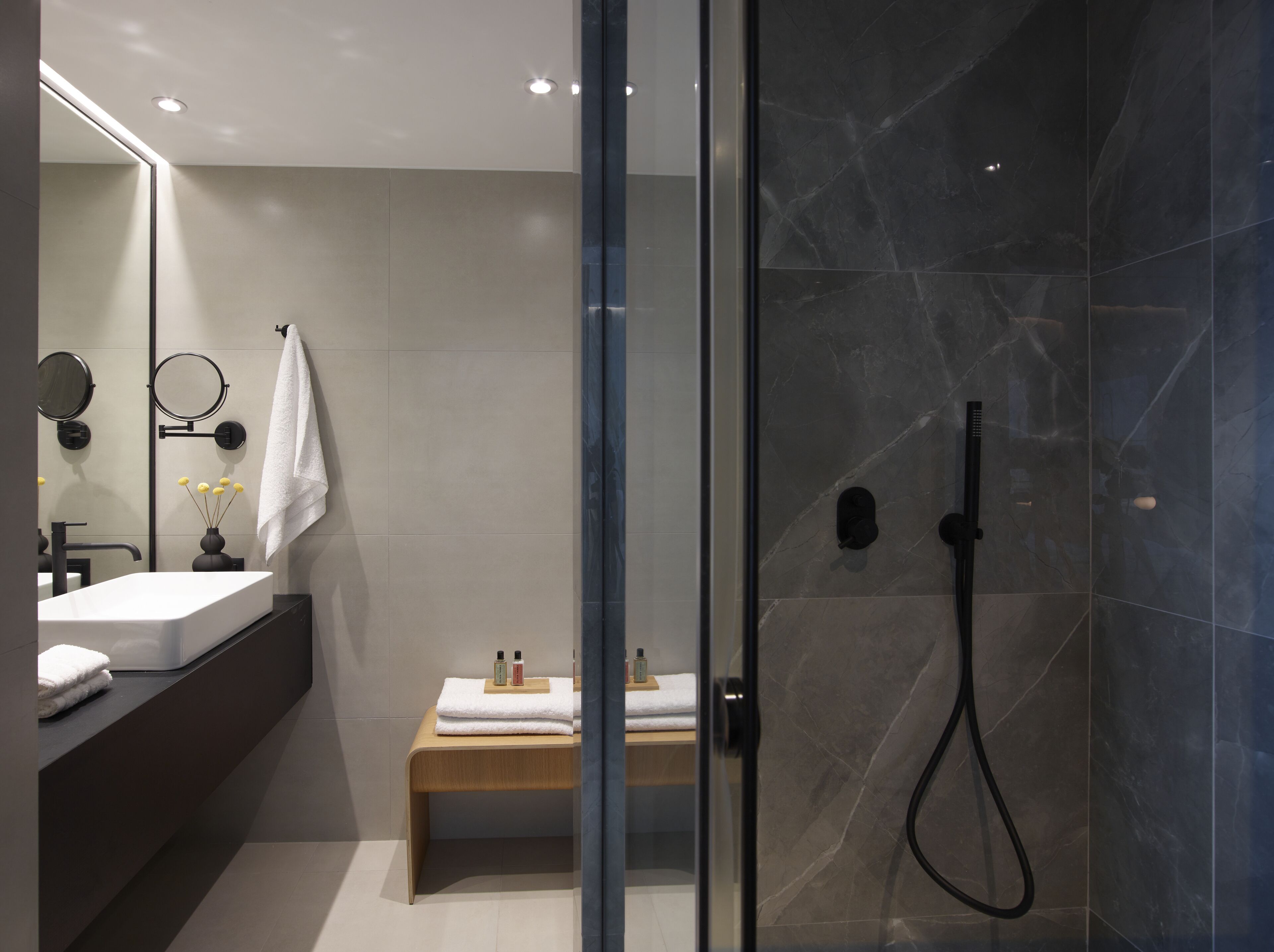 the port square suite | bathroom | rainfall showerhead, designer toiletries, hair dryer, slippers