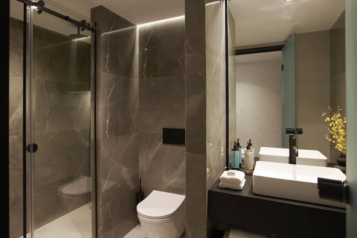 the port double room with balcony and side sea view | bathroom | rainfall showerhead, designer toiletries, hair dryer, slippers