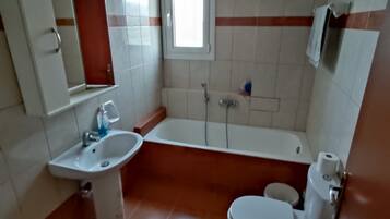 Bathtub, towels, toilet paper