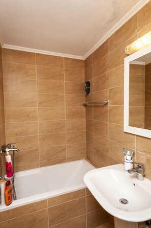 Bathtub, hair dryer, towels, soap