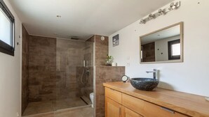 A modern bathroom with a glass-enclosed shower, a wooden vanity with a large sink, and a mirror above the vanity. - A 10 mn walk from the beach with view on the cap canaille house of 100 m2 (CASSIS)