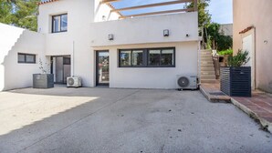 A modern two-story house with a flat roof, large windows, and a covered patio area. - A 10 mn walk from the beach with view on the cap canaille house of 100 m2 (CASSIS)