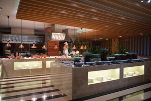 A modern kitchen with a central island, overhead lighting, and a clean, organized layout. - Garrya Xi'an Lintong (Xi'an)