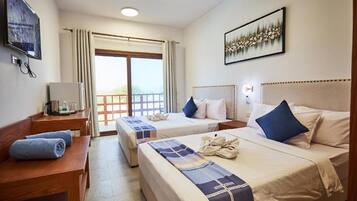 Deluxe Twin Room, Pool View | Minibar, in-room safe, desk, soundproofing