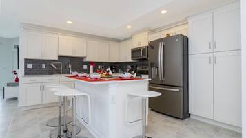 Family Apartment, 3 Bedrooms | Private kitchen | Full-sized fridge, microwave, oven, stovetop