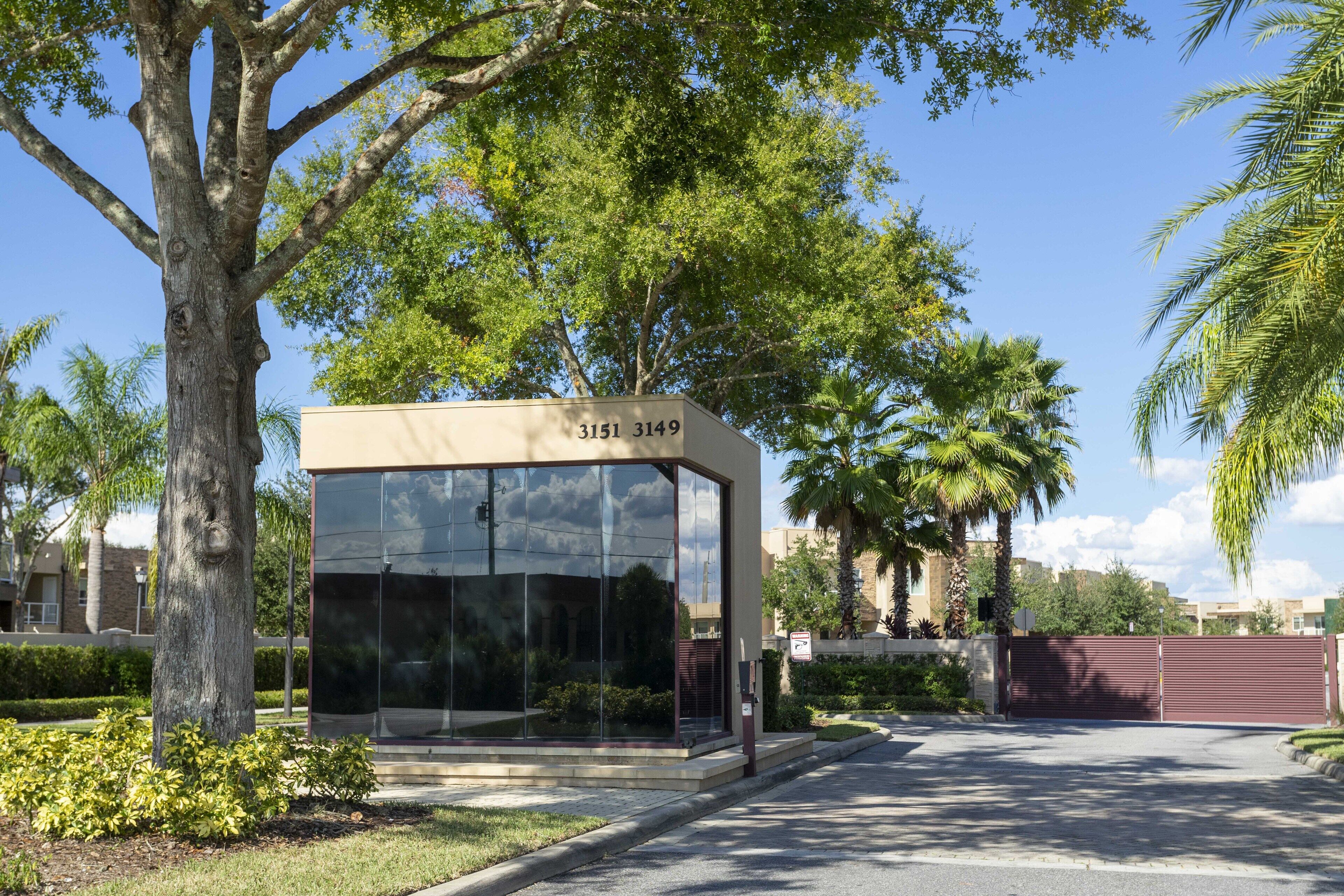 A modern building with a glass facade and a number plaque.