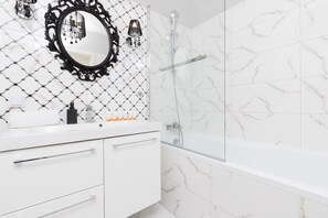 Bathtub, hair dryer, towels, shampoo