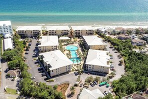 A resort with multiple buildings, a central pool, and a beach view. - Steps to Beach,Gulf Front Pool,Hot Tub-Vitamin Sea (Santa Rosa Beach)