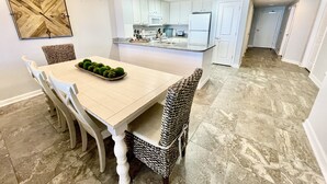 A dining area with a table, chairs, and a chandelier. - PCB - Marisol - Spring and Summer Dates Available!!  Discounted Rates!! (Panama City Beach)