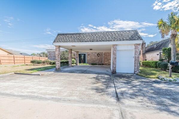 Stylish single-story home with a covered garage and beautifully manicured lawn.