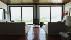 A living room with two sofas, a coffee table, and a fireplace.