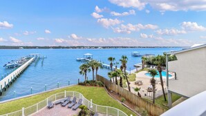 A waterfront property with a dock, a swimming pool, and a view of the water. - Lagoon Front 3 bed 3 bath unit!  Call today New to rental Market. (Gulf Shores)