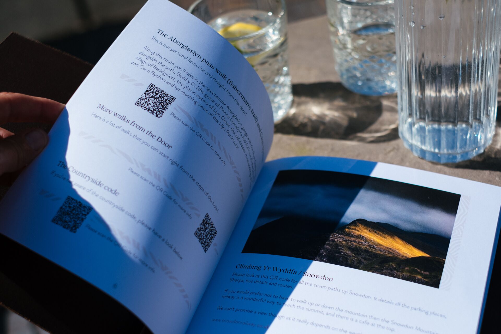 A brochure with QR codes and text about walking routes and climbing Yr Wyddfa / Snowdon.