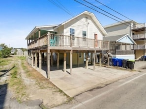 A two-story house with a balcony, a covered porch, and a garage.