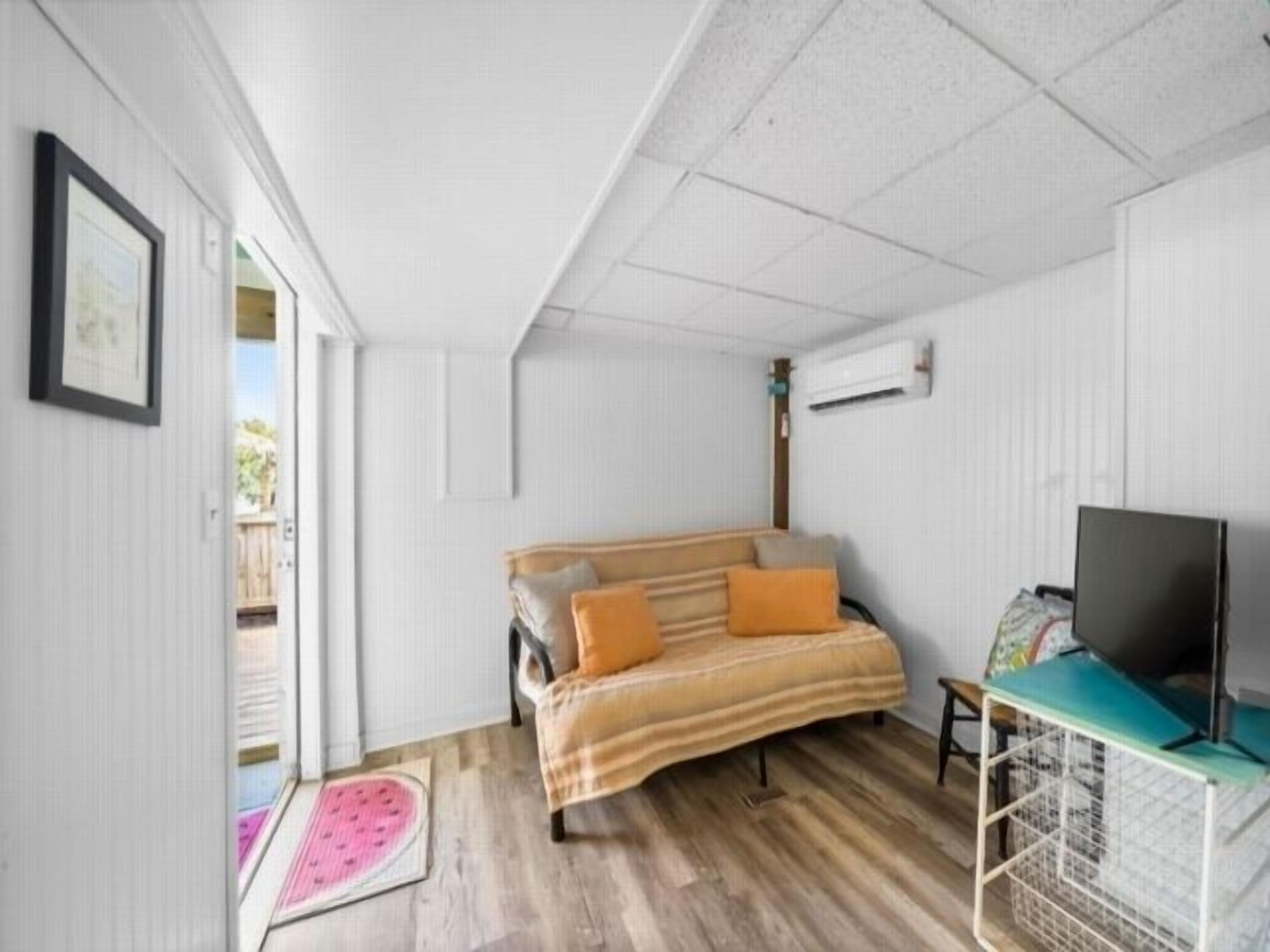 A room with a bed, a desk, and a television.