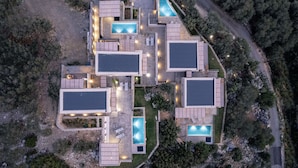 A modern, multi-unit residential complex with multiple swimming pools, outdoor seating areas, and a well-maintained garden. - Metatulia 3 villa,sea views,pool,Souda,Plakias (Plakias)