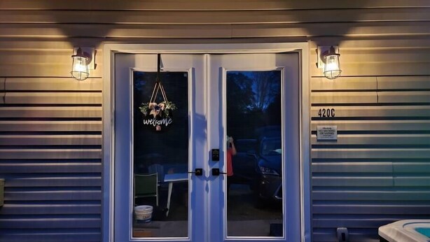 A double door entrance with a 'welcome' sign, a number '420C' sign, and two wall-mounted lights. - You'll be so happy, you'll want to "Just Dance" (Dandridge)