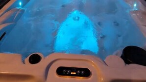 A hot tub with a wooden frame and a control panel. - You'll be so happy, you'll want to "Just Dance" (Dandridge)