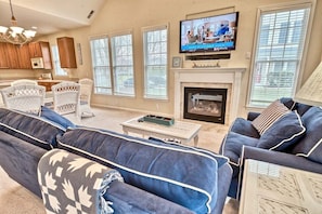 A living room with a fireplace, television, and seating area.