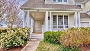 A two-story house with a porch, a front door, and a mailbox. - Bear Trap Dunes * 4BR Bethany Beach Luxury Home (Ocean View)